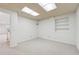 Spacious carpeted basement area with built-in shelving and bright lighting at 244 Saint Patrick Sw Dr, Mableton, GA 30126