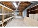 Unfinished basement space with exposed beams, shelving, and utility access at 244 Saint Patrick Sw Dr, Mableton, GA 30126