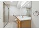 Bathroom featuring tiled floors, a vanity, and a walk-in shower at 244 Saint Patrick Sw Dr, Mableton, GA 30126
