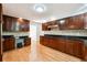 Bright kitchen with dark wood cabinets, stone backsplash, and stainless appliances at 244 Saint Patrick Sw Dr, Mableton, GA 30126