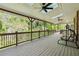 Inviting covered back porch with ceiling fans and wooded views at 244 Saint Patrick Sw Dr, Mableton, GA 30126