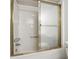 Clean shower with sliding glass doors and chrome fixtures at 244 Saint Patrick Sw Dr, Mableton, GA 30126