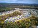 Expansive aerial view of a community nestled amongst colorful fall foliage and rolling hills at 419 Murphy Ave, Canton, GA 30114
