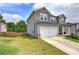 A well-maintained backyard with a lush green lawn, framed by a wooden fence and neighboring houses at 419 Murphy Ave, Canton, GA 30114