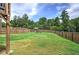 Large, fenced backyard, showcasing a well-maintained lawn and a playset for , offers a private outdoor space at 419 Murphy Ave, Canton, GA 30114