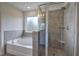 Modern bathroom featuring a soaking tub, a walk-in shower with gray tiling, and a frosted window at 419 Murphy Ave, Canton, GA 30114