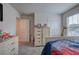 Bedroom featuring themed bed, a gray dresser, giraffe decoration, and bright sunlight from the window at 419 Murphy Ave, Canton, GA 30114