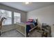 Bedroom featuring a bed, toys, and bright sunlight from the two windows at 419 Murphy Ave, Canton, GA 30114