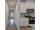 Modern kitchen featuring white cabinetry, stainless steel appliances, and stylish wood-look flooring at 419 Murphy Ave, Canton, GA 30114