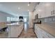 Open-concept kitchen with white cabinets, island, stainless appliances, and sightlines to the living room at 419 Murphy Ave, Canton, GA 30114