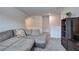 Open living room features neutral walls and carpet, a plush sectional sofa, and stylish shelving for entertainment at 419 Murphy Ave, Canton, GA 30114