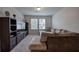 Comfortable living room featuring a sectional sofa, entertainment center, and natural light from the window at 419 Murphy Ave, Canton, GA 30114