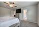 Relaxing main bedroom featuring a ceiling fan, large tv, closet, and ensuite bathroom at 419 Murphy Ave, Canton, GA 30114