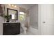Charming bathroom with tile floors, shower and tub combo, and a dark vanity at 4585 Woodland Bank Blvd, Buford, GA 30518