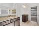 Bathroom with granite countertop vanity, tiled floors and shower with large mirrors at 4585 Woodland Bank Blvd, Buford, GA 30518