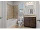 Bathroom with granite countertops, tile flooring, and a tub and shower combo at 4585 Woodland Bank Blvd, Buford, GA 30518