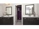 Double vanity bathroom with granite countertops, dark wood cabinets, framed mirrors, and an open doorway at 4585 Woodland Bank Blvd, Buford, GA 30518