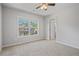 Spacious bedroom with carpet flooring and a window providing natural light at 4585 Woodland Bank Blvd, Buford, GA 30518