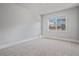 Bright bedroom with neutral carpet and a large window for natural light at 4585 Woodland Bank Blvd, Buford, GA 30518