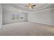 Spacious primary bedroom featuring trey ceilings, carpet, and large windows for natural light at 4585 Woodland Bank Blvd, Buford, GA 30518