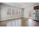 Sun-filled dining area with hardwood floors, stainless steel appliances, and natural light at 4585 Woodland Bank Blvd, Buford, GA 30518