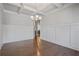 Spacious dining room with coffered ceilings, decorative chandelier, and hardwood flooring at 4585 Woodland Bank Blvd, Buford, GA 30518