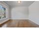 Bright, spacious room with hardwood floors, large window and neutral wall paint at 4585 Woodland Bank Blvd, Buford, GA 30518