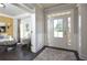 Bright foyer with a view to living room and entryway with elegant rug and decor at 4585 Woodland Bank Blvd, Buford, GA 30518