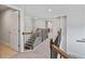 Hallway with carpet flooring and wood-and-wrought iron banister overlooking the staircase at 4585 Woodland Bank Blvd, Buford, GA 30518