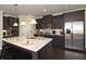 Modern kitchen with granite countertops, island and stainless appliances at 4585 Woodland Bank Blvd, Buford, GA 30518