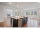 Open kitchen featuring an island, stainless steel appliances, and hardwood flooring at 4585 Woodland Bank Blvd, Buford, GA 30518