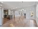 Open-concept living space featuring an island kitchen, fireplace, and hardwood floors at 4585 Woodland Bank Blvd, Buford, GA 30518