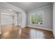 Light filled living room with hardwood floors, white trim, and large windows at 4585 Woodland Bank Blvd, Buford, GA 30518