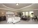 Spacious main bedroom featuring tray ceilings, sitting area, and large windows, creating a relaxing retreat at 4585 Woodland Bank Blvd, Buford, GA 30518