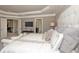 Beautiful main bedroom featuring crown molding, soft lighting, and a doorway leading to an adjacent room at 4585 Woodland Bank Blvd, Buford, GA 30518