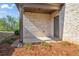 Covered patio area features a brick exterior and is ready for outdoor relaxation and entertaining at 4585 Woodland Bank Blvd, Buford, GA 30518