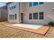 Back patio with brick trim leading to a yard provides a welcoming space for outdoor enjoyment at 4585 Woodland Bank Blvd, Buford, GA 30518