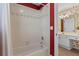 Clean bathroom with a white tiled shower/tub combination and vanity leading to the bedroom at 9860 Hunt Club Way, Johns Creek, GA 30022