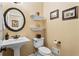 Bathroom features a white pedestal sink, toilet, and decorative shelves at 9860 Hunt Club Way, Johns Creek, GA 30022