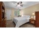 Comfortable bedroom with a ceiling fan, soft natural light, and warm neutral-colored walls at 9860 Hunt Club Way, Johns Creek, GA 30022