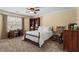 Cozy bedroom featuring a rocking chair, writing desk, shelving, and a large window for bright natural light at 9860 Hunt Club Way, Johns Creek, GA 30022