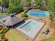 Aerial view of community pool, tennis courts, and playground at 9860 Hunt Club Way, Johns Creek, GA 30022