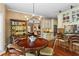 Open-concept dining area seamlessly connects to the kitchen with a view of the living area at 9860 Hunt Club Way, Johns Creek, GA 30022