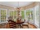 Cozy dining room featuring a round table with large windows providing natural light at 9860 Hunt Club Way, Johns Creek, GA 30022