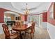Charming formal dining room featuring an open floorplan transitioning to the piano room at 9860 Hunt Club Way, Johns Creek, GA 30022