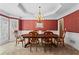 Formal dining room with an elegant chandelier, decorative wallpaper, and ample natural light at 9860 Hunt Club Way, Johns Creek, GA 30022