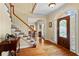 Inviting foyer with hardwood floors, a staircase with white railings, and a decorative glass front door at 9860 Hunt Club Way, Johns Creek, GA 30022