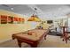Finished basement with a pool table and gym equipment, providing ample entertainment options at 9860 Hunt Club Way, Johns Creek, GA 30022