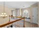 Bright hallway with a window seat and a decorative chandelier, offering a cozy reading spot at 9860 Hunt Club Way, Johns Creek, GA 30022