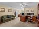 Well-lit home office features a large sofa, bright natural light, and multiple desks to support productivity at 9860 Hunt Club Way, Johns Creek, GA 30022